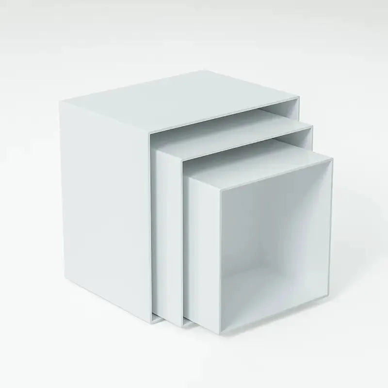 Set of six white plastic cube-shaped dessert display stands arranged on a desktop.