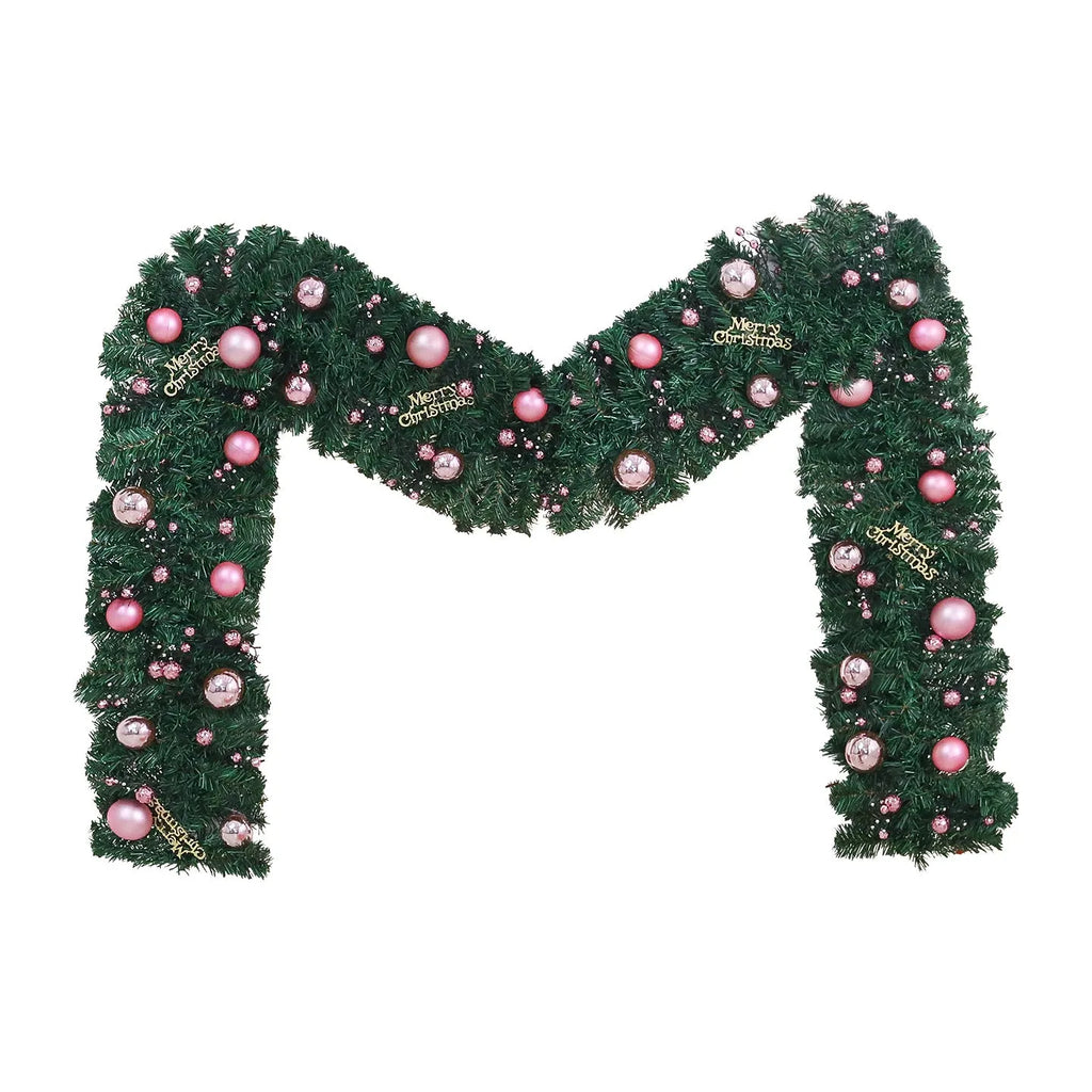 2.7 metre pink Christmas rattan garland with small fruit details and LED string lights displayed along mantelpiece