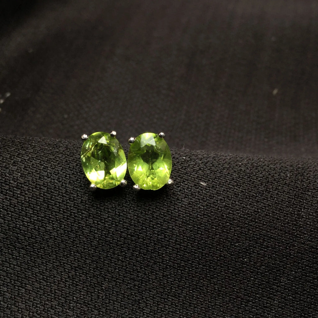 Natural olivine stud earrings in grass green set in S925 silver with 6×8mm oval faceted stone