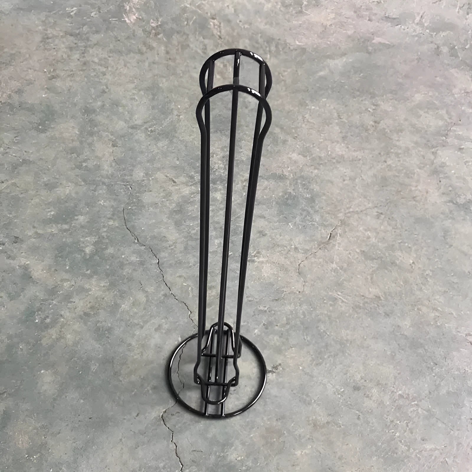 Modern wrought iron coffee capsule storage rack holding pods on display shelves