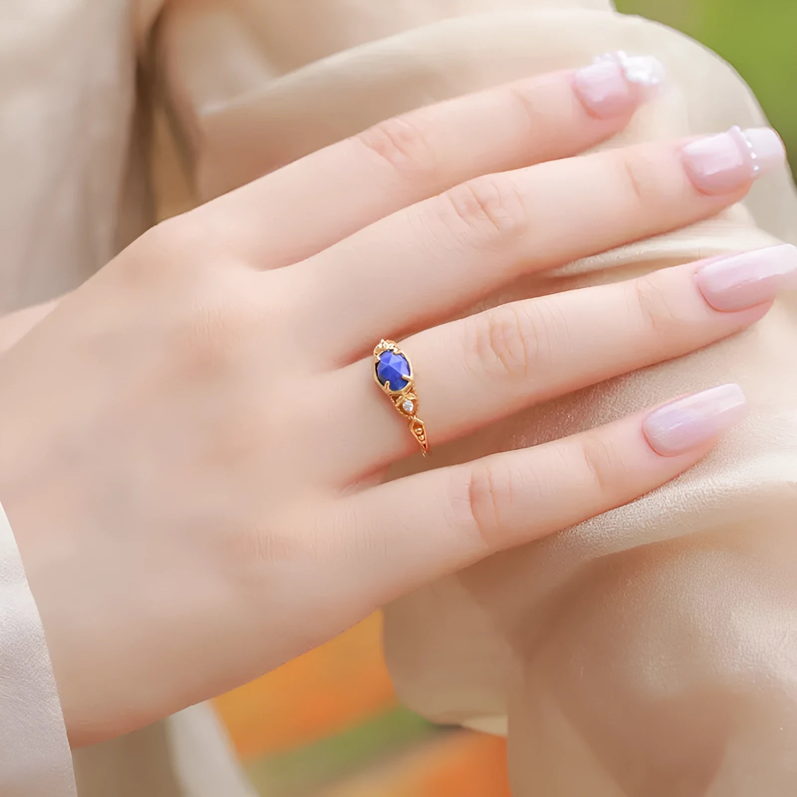 Geometric silver ring with deep blue lapis lazuli stone, elliptical shape with round decorative elements