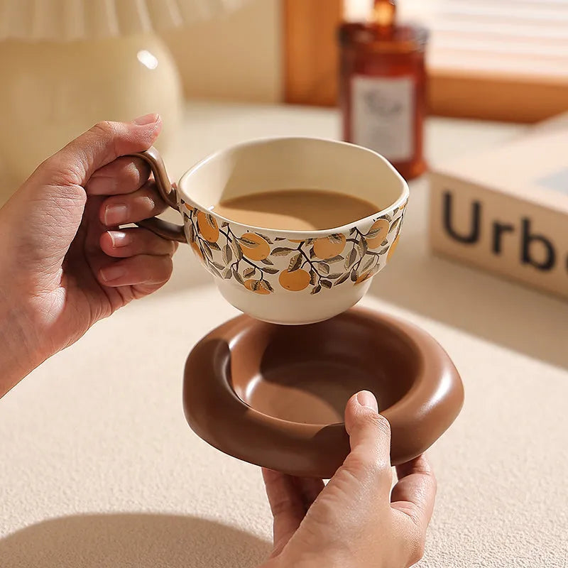 Antique style ceramic coffee cup and saucer set in black pomegranate or orange citrus retro design.