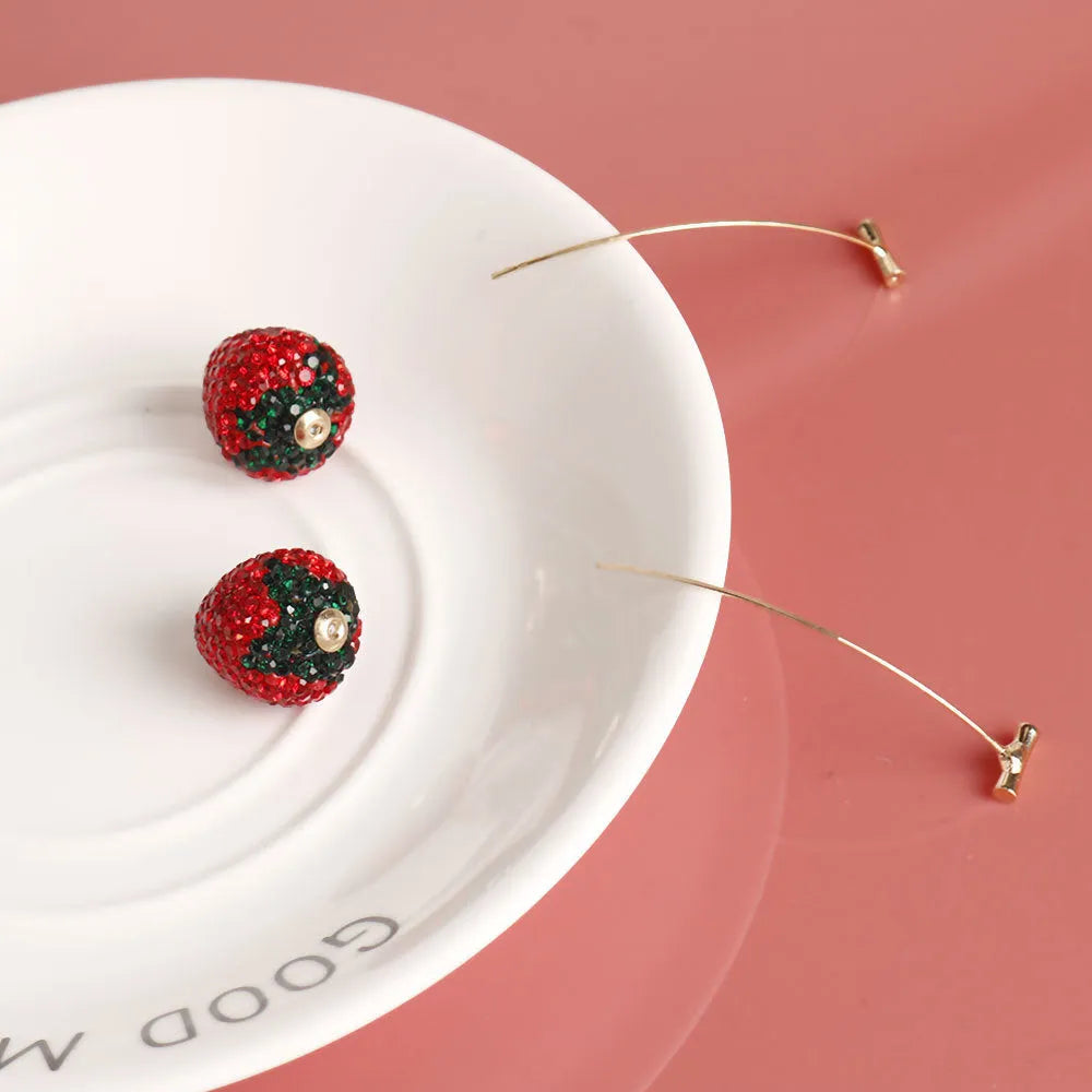 Geometric strawberry-shaped stud earrings with spot drill crystal details in red colour option
