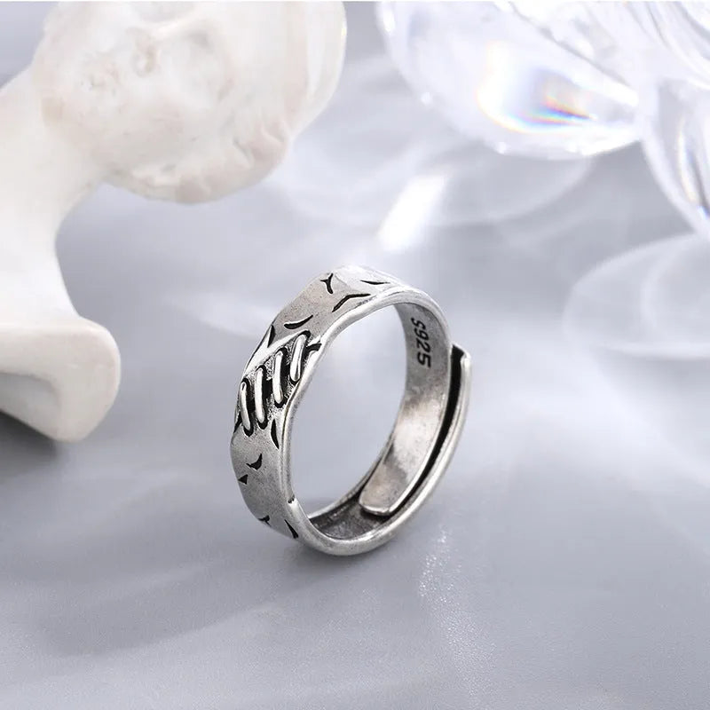 Black geometric copper women's ring with adjustable opening showing round and oval design elements
