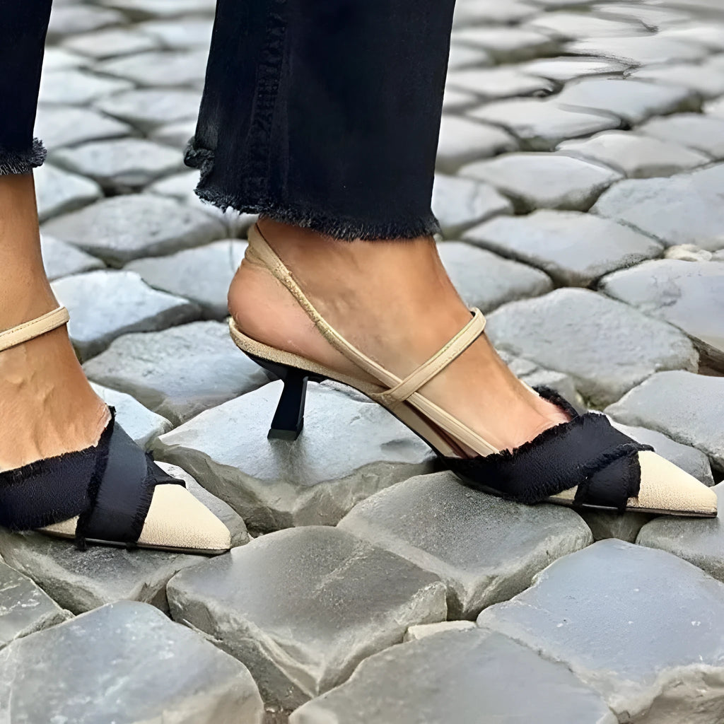 Women's apricot and black colour block stiletto heel sandals with a pointed toe and buckle fastening.