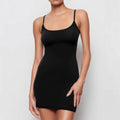 Black slim-fit sheath dress with sling neckline and sleeveless design on a mannequin.