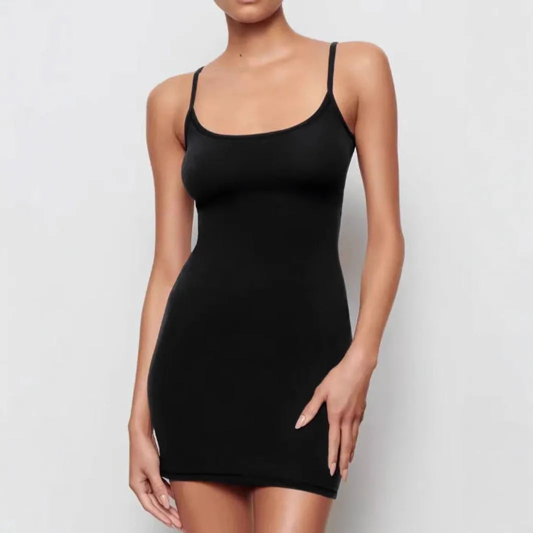 Black slim-fit sheath dress with sling neckline and sleeveless design on a mannequin.
