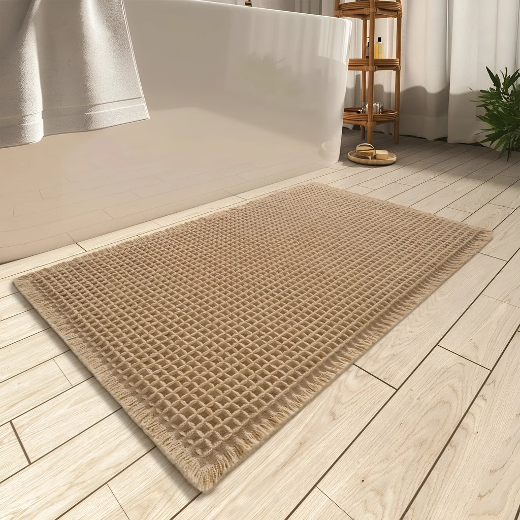 Beige and white checkered woven polyester bathroom floor mat on tiles.
