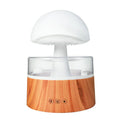White cloud-shaped humidifier with LED lighting and raindrop simulation on wooden surface