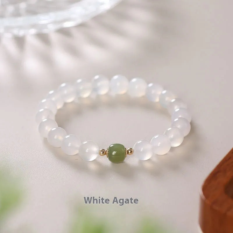 A handmade white agate style crystal bracelet with cinnabar inlay, shown in 6mm and 8mm bead sizes.