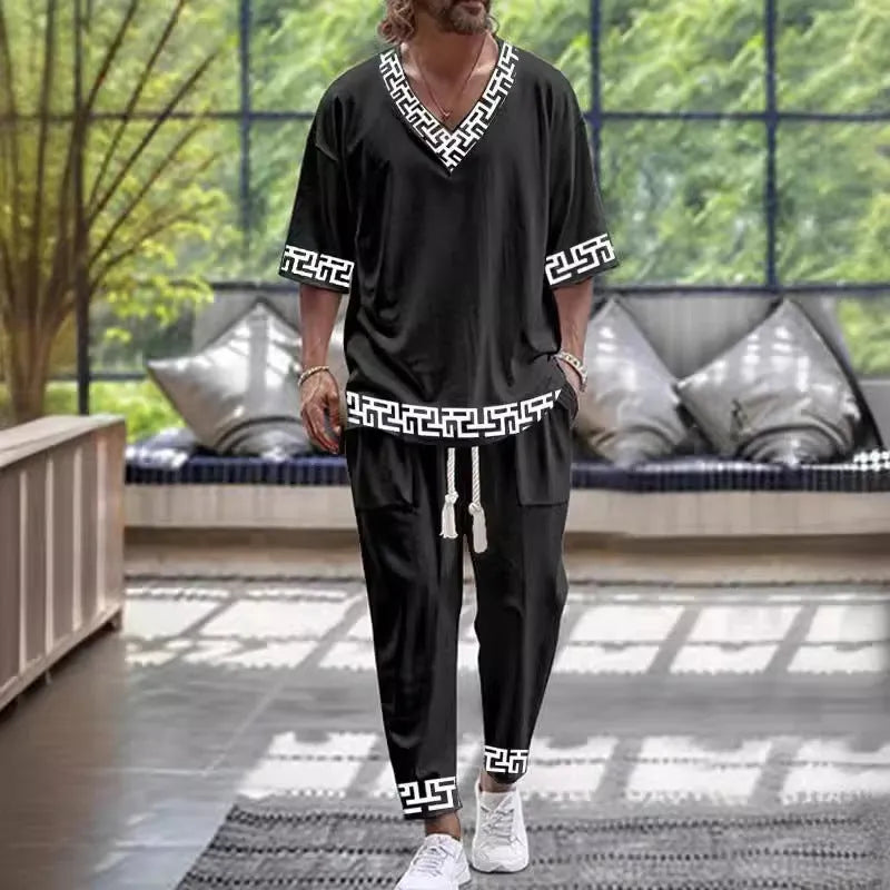 Thin polyester trousers suit with a cropped sleeve V-neck jacket on a hanger.
