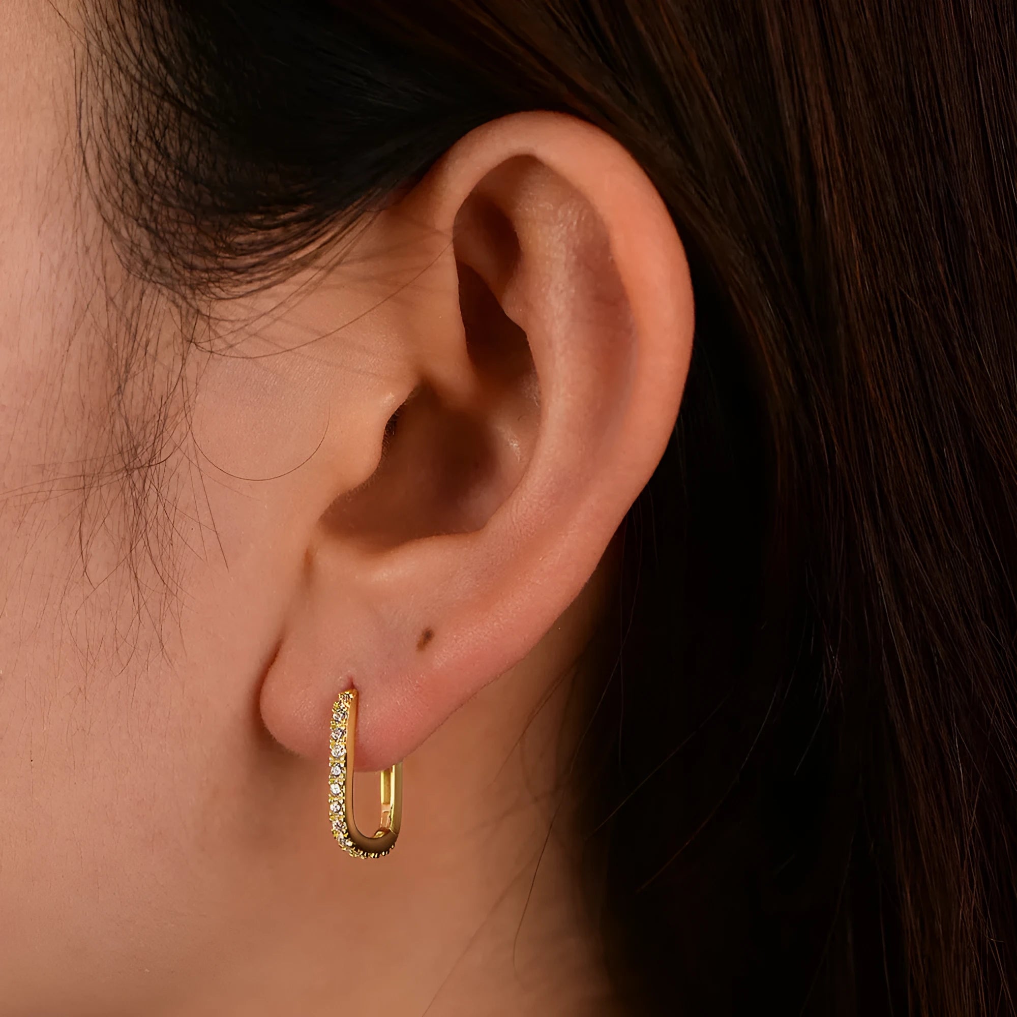 S925 sterling silver oval zircon ear clips on ear, shown in yellow and white colour options.
