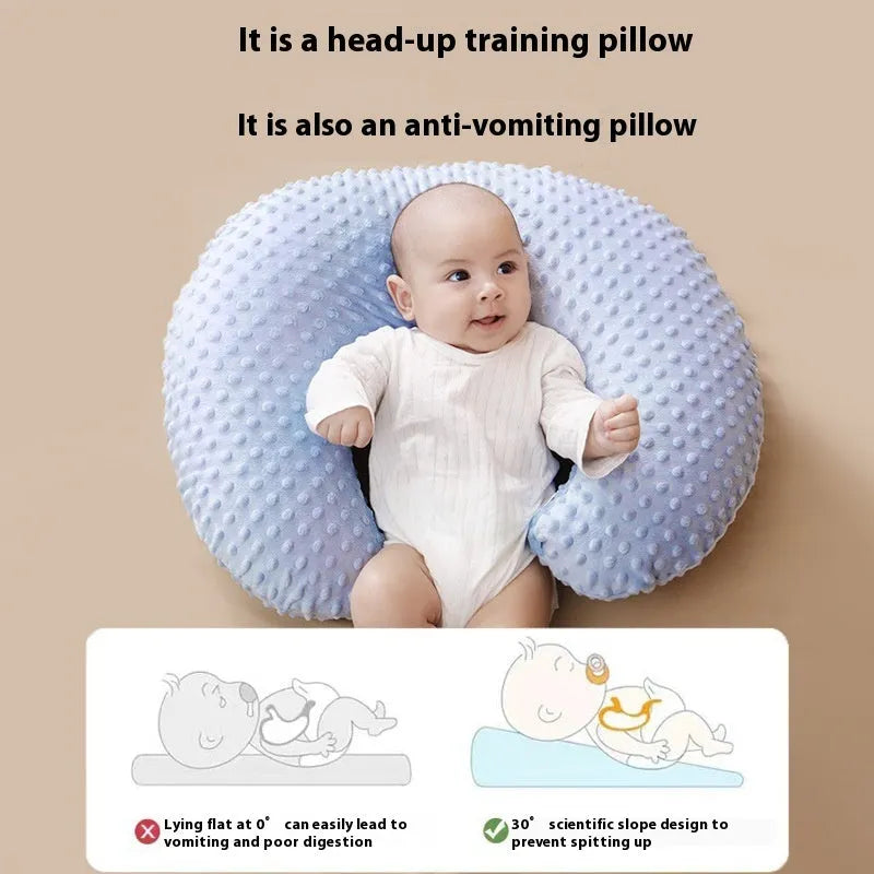 Multifunctional nursing pillow in light blue colour for breastfeeding support and spill prevention.