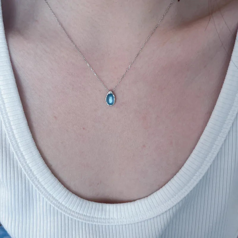 Women's navy blue geometric water drop pendant on an adjustable silver-toned chain.