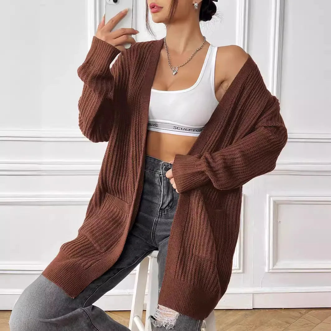 Women's dark green loose-fit cardigan with two front pockets and long sleeves