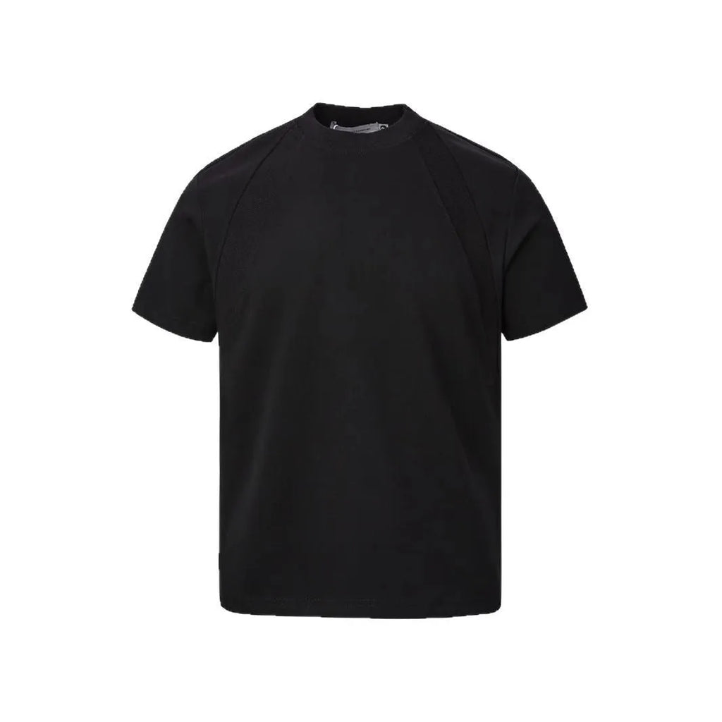 Man wearing a loose fit grey short sleeve top with visible air layer stitching texture.