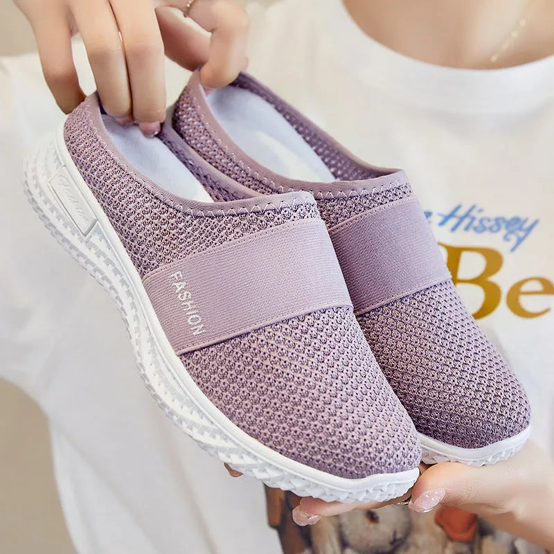 Women's black breathable mesh casual shoes with hollow-out details and a flat round toe.
