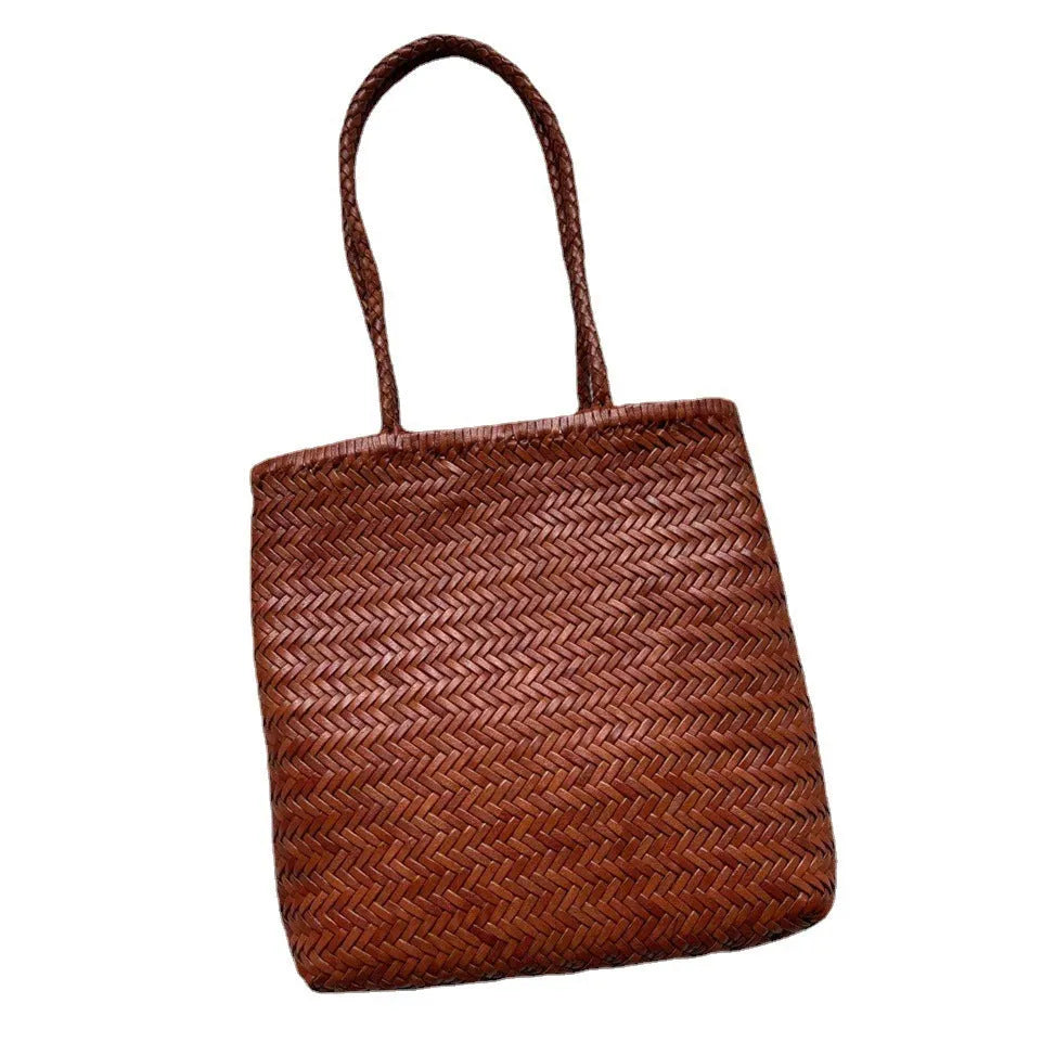 Brown handmade woven leather tote bag with three-dimensional pocket showing vintage texture