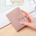 Lychee pattern textured ladies' two-fold short wallet in beige, pink, black, and red colour options.
