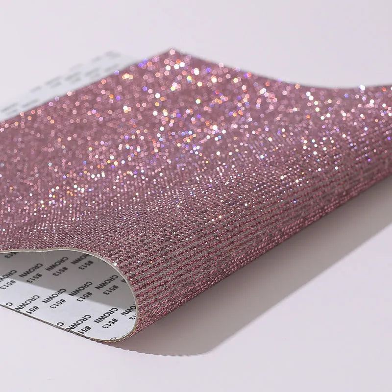 Sheet of rhinestones in an eight-eye pattern on a glue net backing, showing multiple colour options.