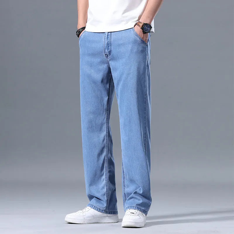 Men's loose fitting straight-leg jeans in lyocell fabric, shown in a light blue colour