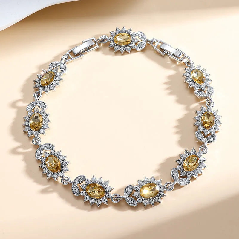 Simple women's bracelet with inlaid zircon stone on an adjustable electroplated alloy band.