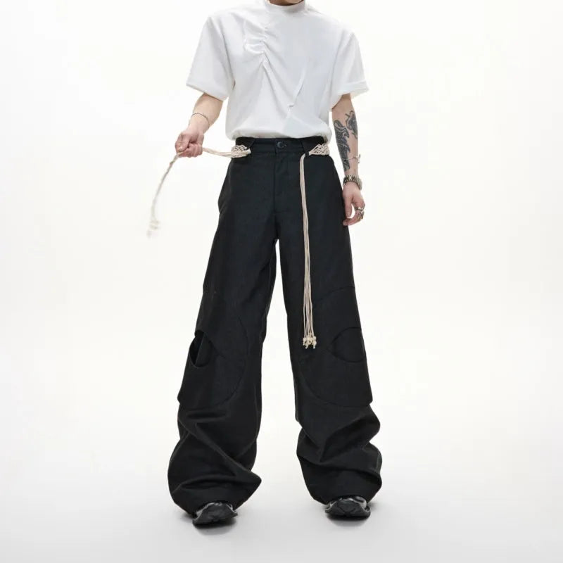 Men's dark blue cotton straight-leg jeans with loose fit, showing heavy 3D cutting, belt stitching, and decorative zip details.