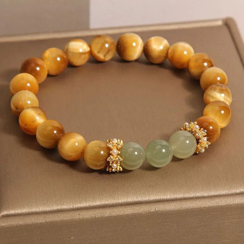 Natural yellow tiger's eye Hetian jade bracelet in u-shaped design with auspicious patterns.