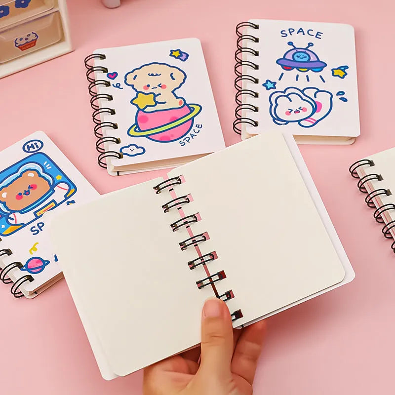 Astronaut-themed pocket flipper notebook showing compact 10.5 by 8 cm dimensions with space character cover options