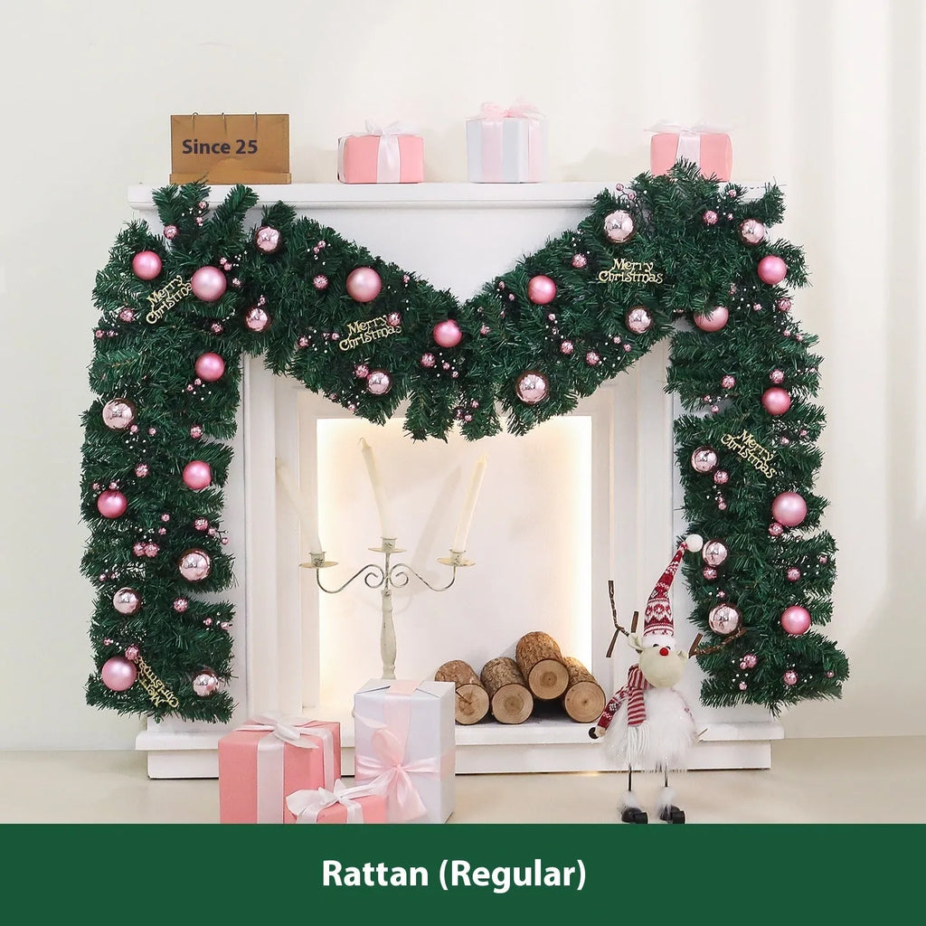 2.7 metre pink Christmas rattan garland with small fruit details and LED string lights displayed along mantelpiece