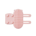 Silicone cat grooming comb with adjustable strap mounted on table leg