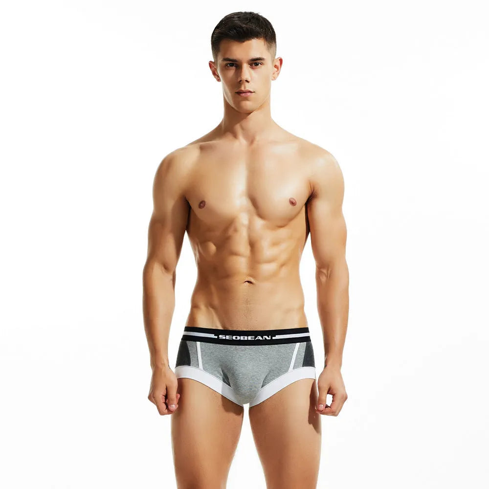 Men's cotton low-waist boxers in red, dark blue, and light grey colours showing hip-lifting design