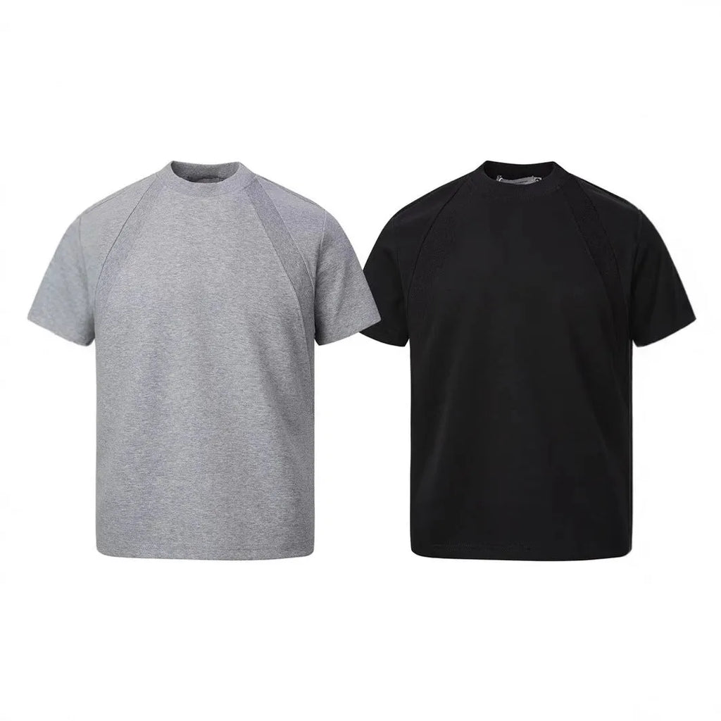 Man wearing a loose fit grey short sleeve top with visible air layer stitching texture.