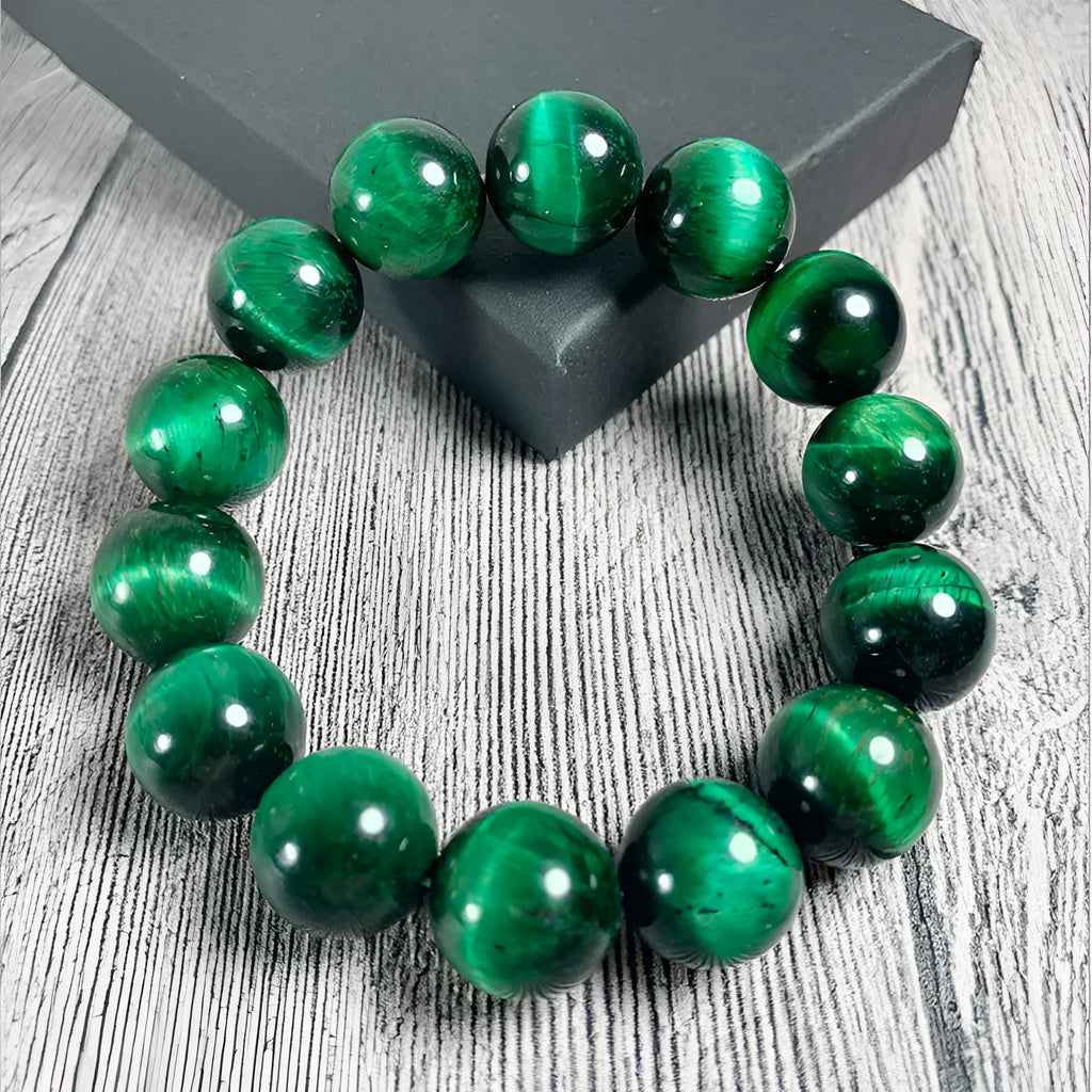 Polished green tiger eye stone bracelet with geometric beads on a wrist, showing size options.