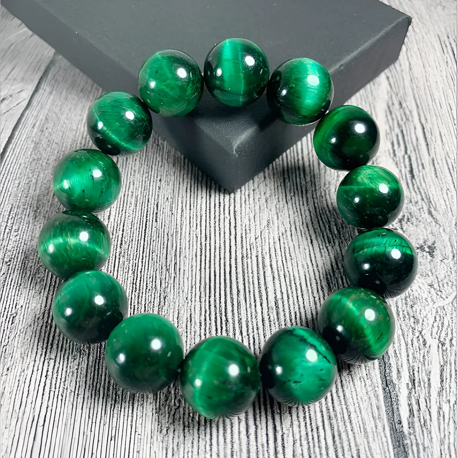 Polished green tiger eye stone bracelet with geometric beads on a wrist, showing size options.
