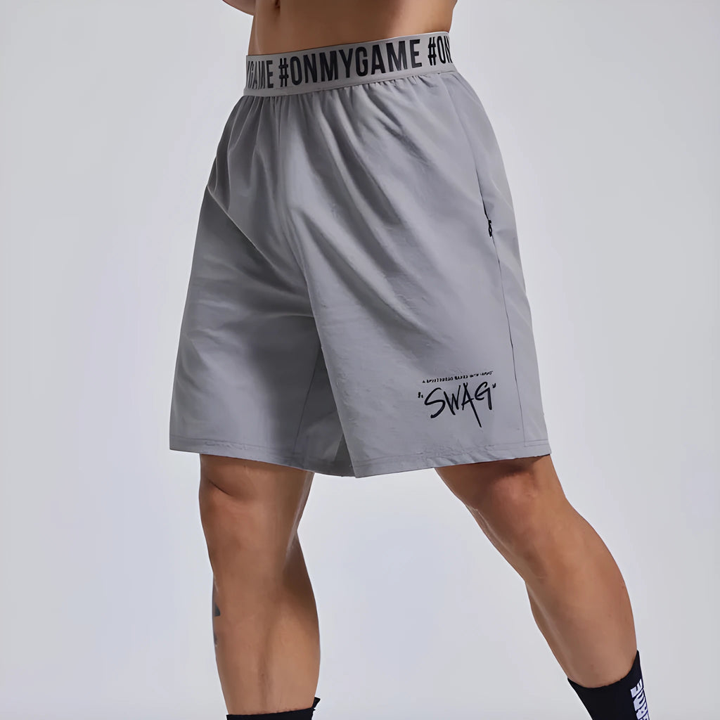 Men's loose grey sports shorts with elastic fly opening and letter detailing for athletic wear