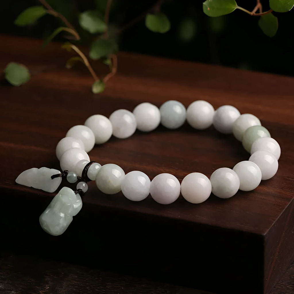 Natural green jade hanging bracelet with Maitreya Buddha pendant on a wrist.
