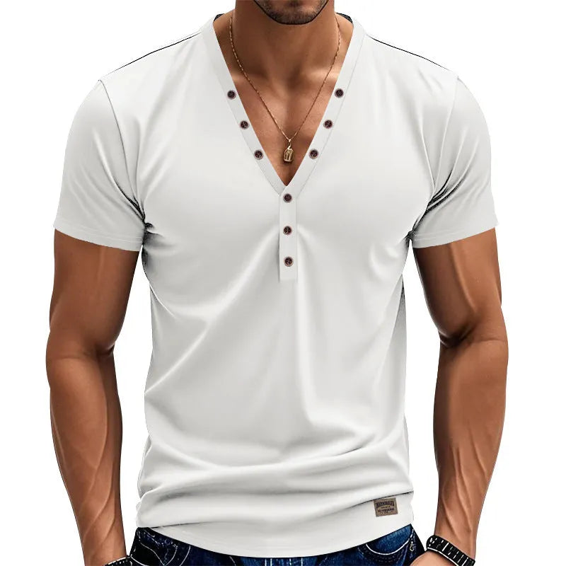 Man wearing a loose fit solid colour V-neck pullover top with a small button design detail.