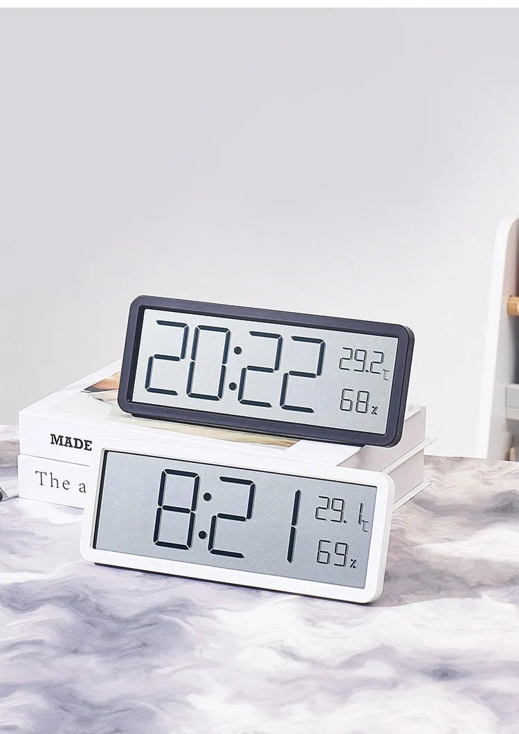 Simple large screen temperature and humidity clock with plastic shell in white Nordic style on a desk