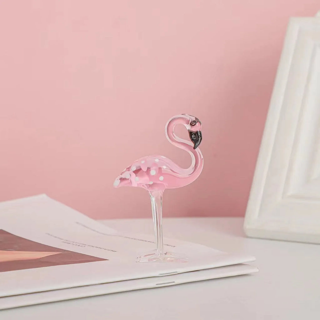 Pink crystal flamingo decorative ornament on a table, modern minimalist style.