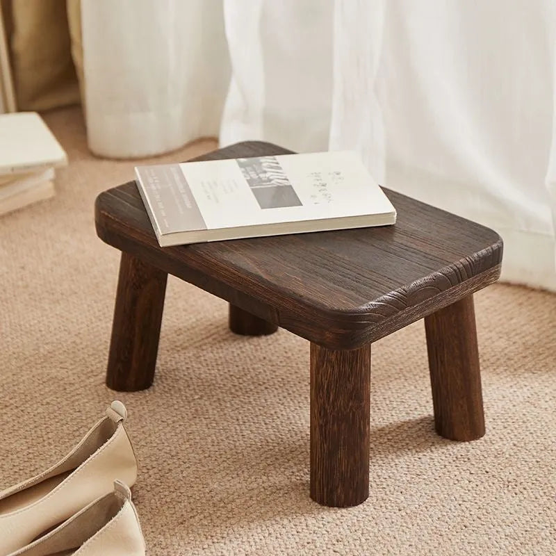 Distressed brown wooden stool with bracket legs for changing shoes