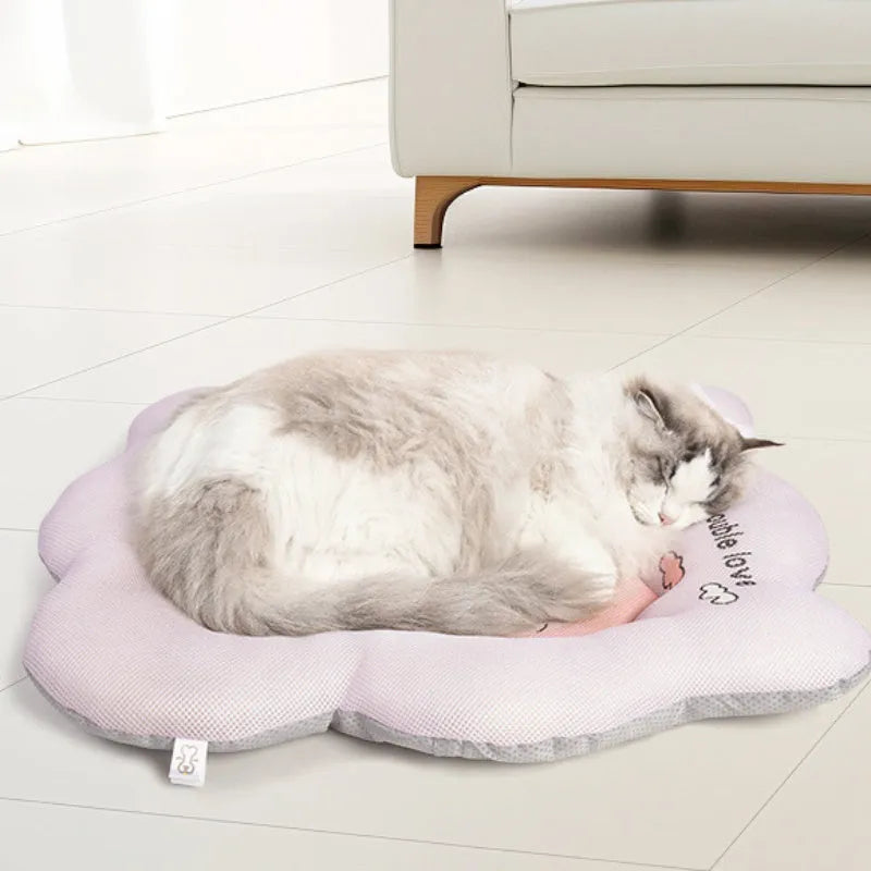 Green pet cooling mat for dogs and cats on a wooden floor.
