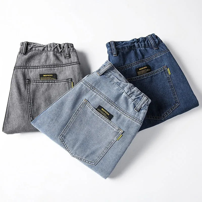 Men's loose fit straight leg jeans in cotton denim shown in dark blue, mid waist with zipper fly