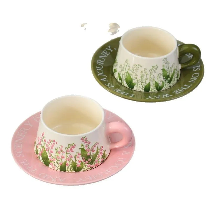 Ceramic coffee cup and saucer set with two cups, two saucers, and two stirring spoons