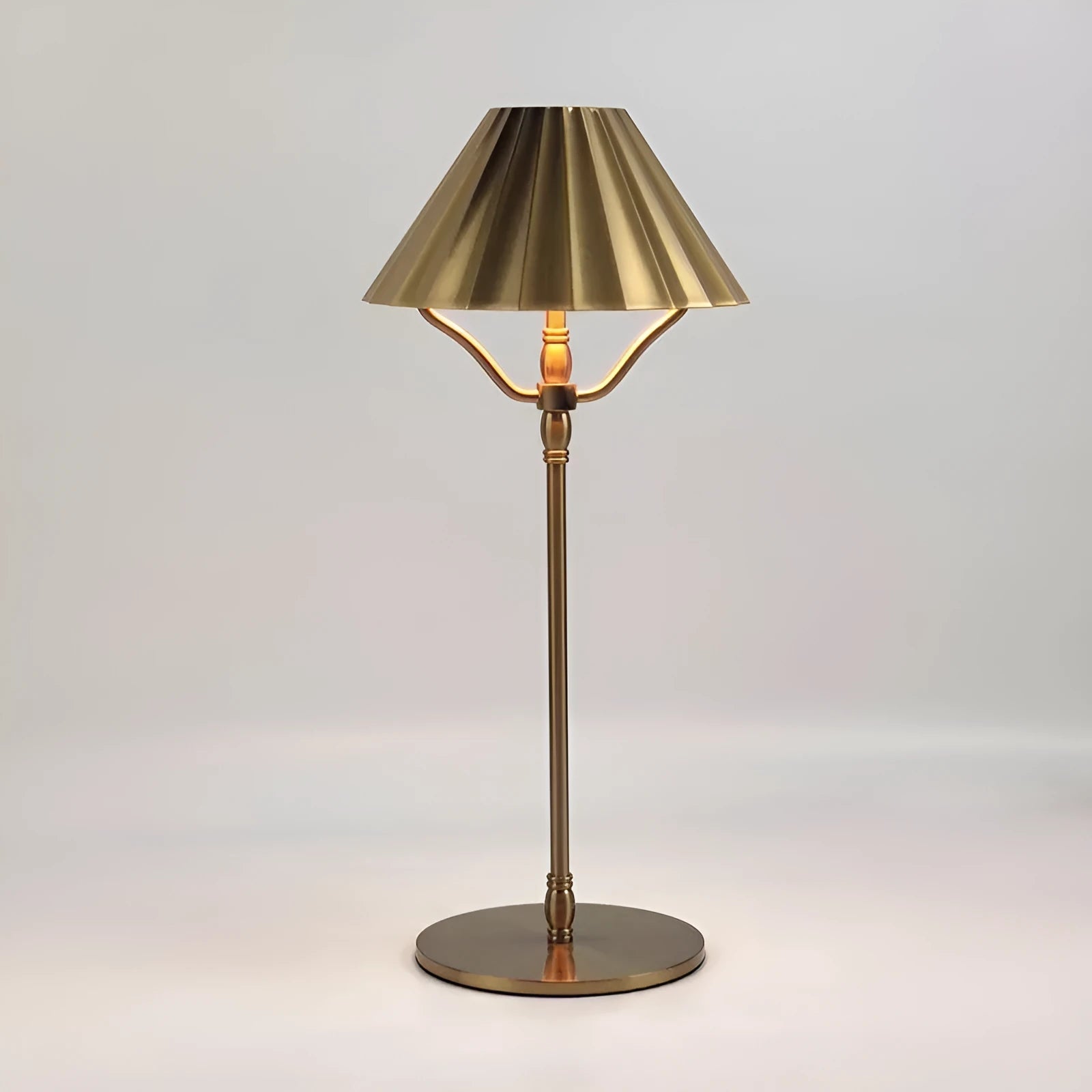 Gold alloy desk lamp with touch control on a wooden desk.