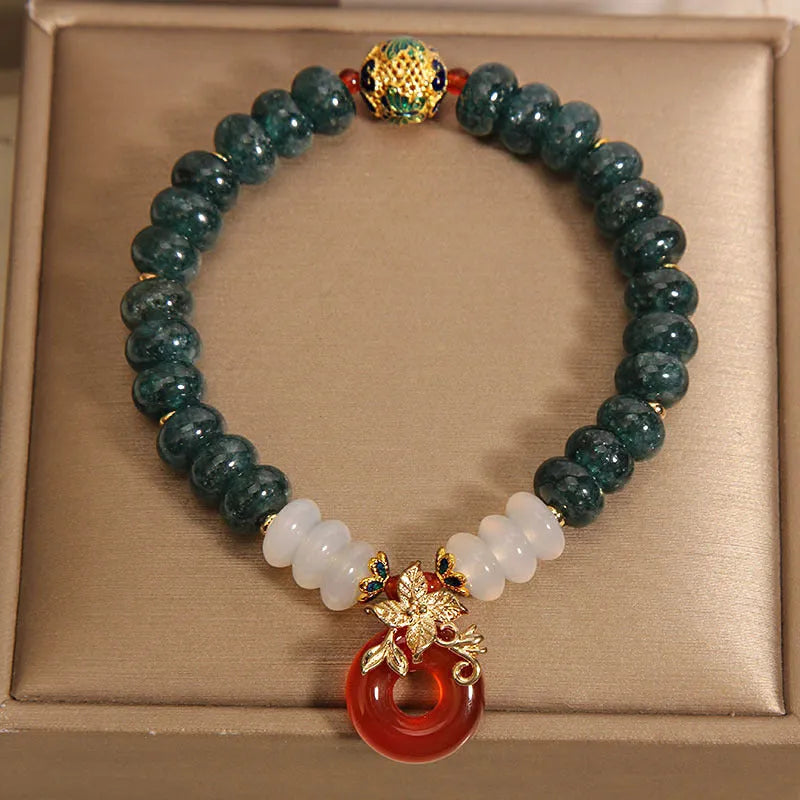 Women's blue water jade and red agate crystal bracelet with peace buckle closure