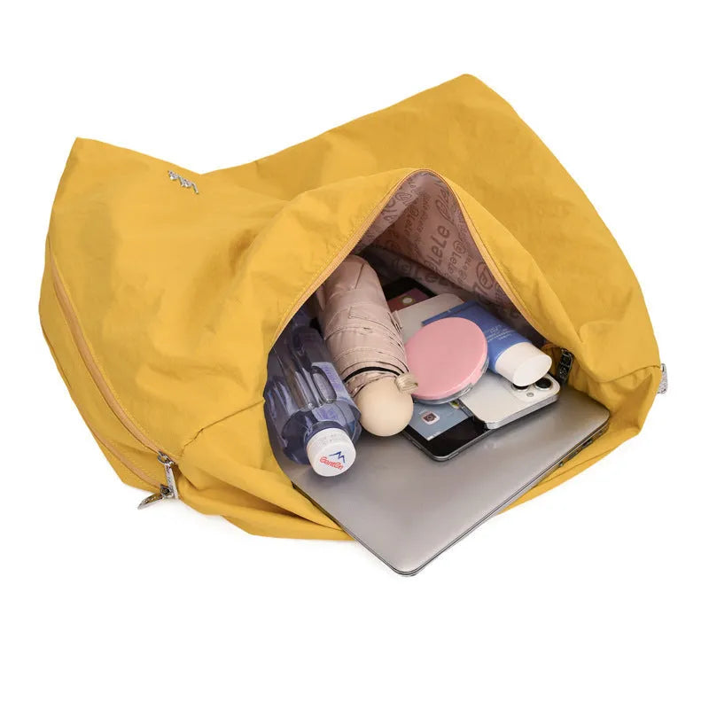 Women's heart-shaped nylon underarm bag in black, blue, khaki, and yellow colour options showing large capacity design