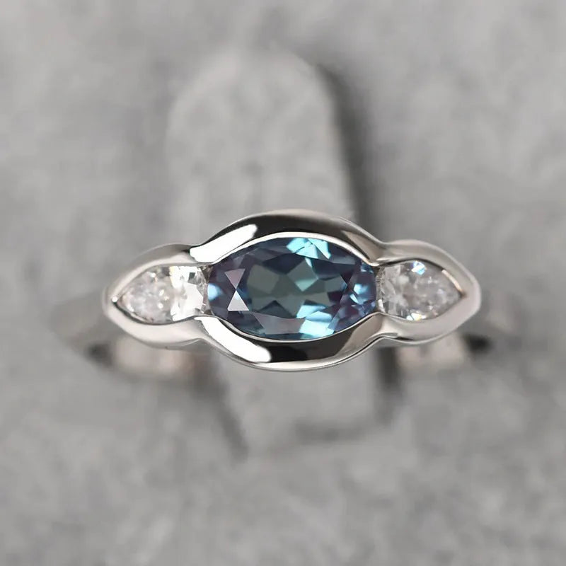 Geometric ellipse women's ring with inlaid zircon stones in white gold colour