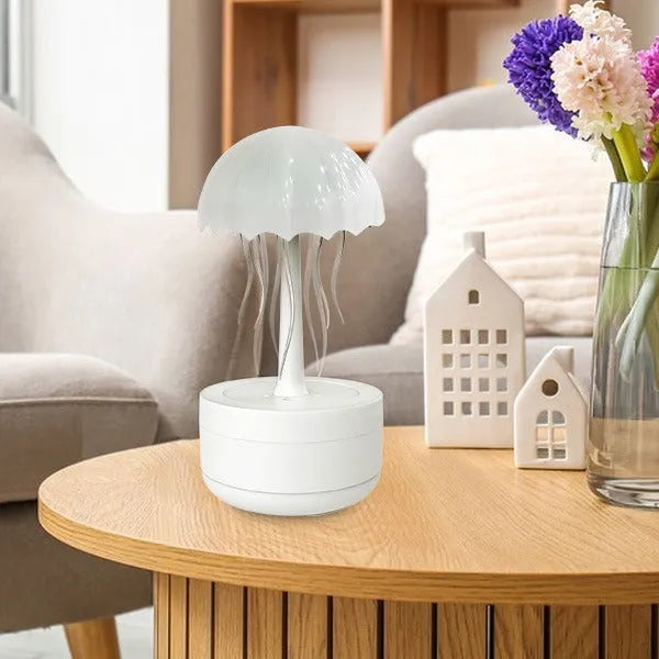 White jellyfish-shaped humidifier diffuser with colourful LED lights and visible mist output