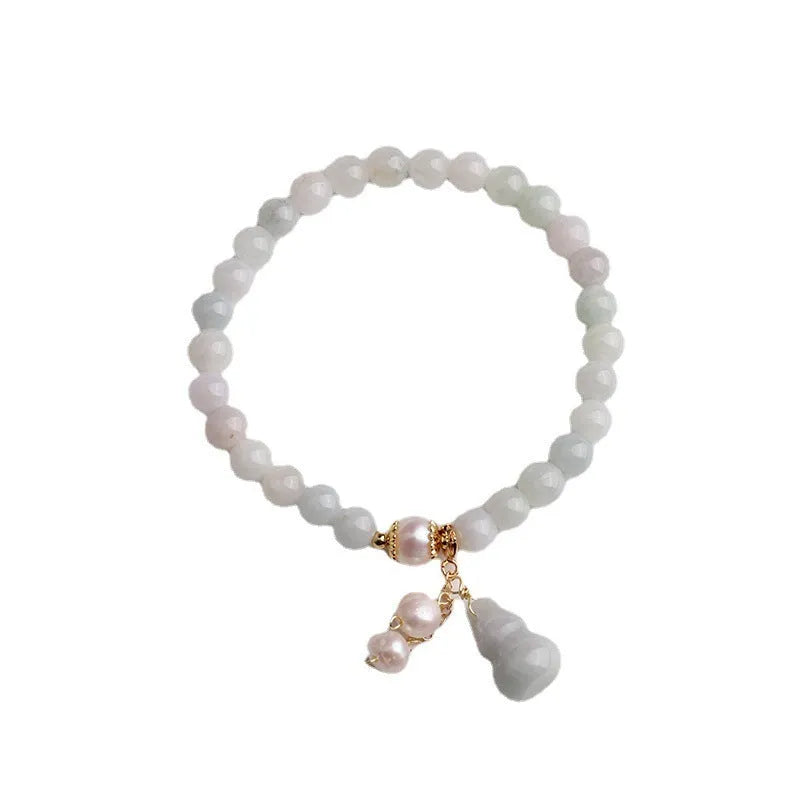 Emerald green jade bracelet with a raised gourd design in a Chinese style.